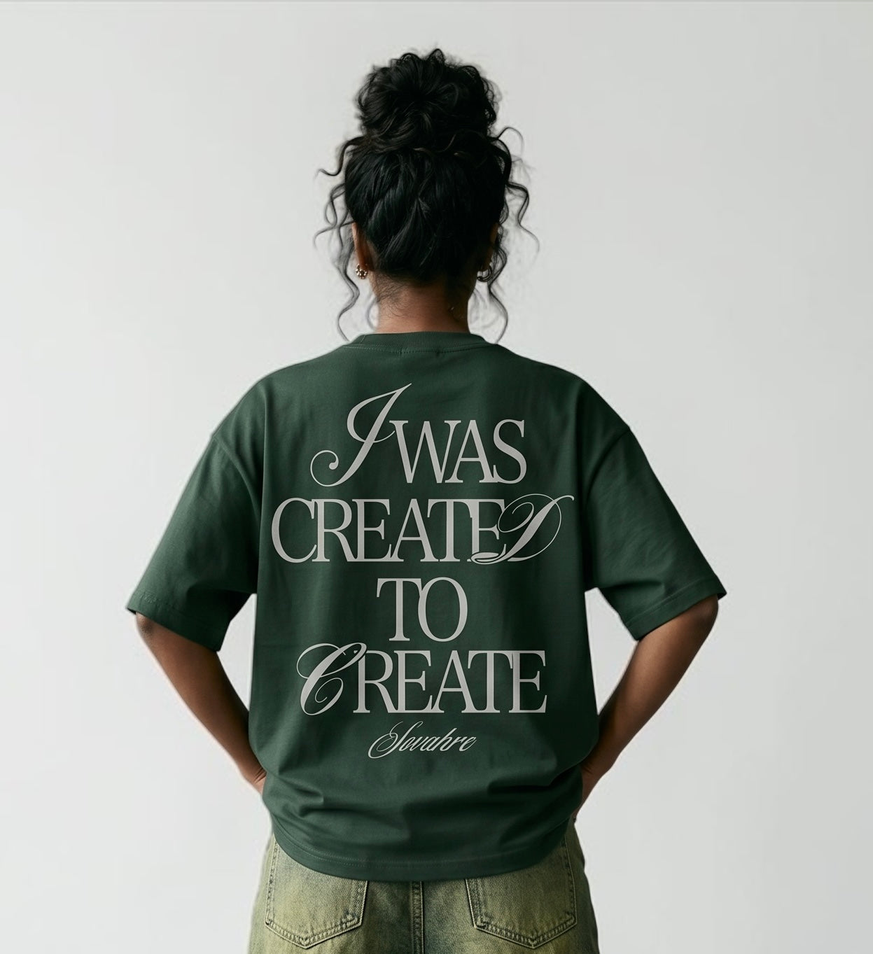 Person wearing a green t-shirt with text on the back against a plain background